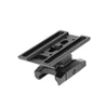 Black metal optic riser mount with Picatinny rail base on a white background
