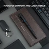 A 6.10-inch black tactical pen with LED light and clip, next to a keyboard, keychain, and wallet.