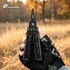 HX Outdoors black tactical multitool pliers held by gloved hand in autumn field environment