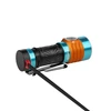 Olight Baton 4 in orange and teal, with a charging cable connected to its tailcap.