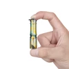 Hand holding Olight i3E EOS tiny keychain flashlight with yellow and blue palm tree pattern on white background