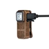 Olight clip-on work light with distressed copper finish, charging via USB cable.