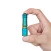 Hand holding a tiny turquoise Olight i3E EOS keychain flashlight showcasing its compact and portable size