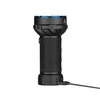 Black tactical LED flashlight with blue trim, textured grip, charging cable connected, white background
