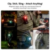 Olight Oclip Pro mounted on a tactical vest with red light for versatile outdoor use.
