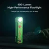 Green zombie-themed 400-lumen high-performance flashlight emitting bright light on dark background with paracord.