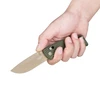Hand holding OKNIFE EDC folding knife with olive green handle and desert tan blade.