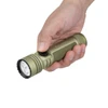 Hand holding Olight Seeker Ultra OD green tactical flashlight against white background