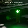 Compact EDC flashlight emitting bright green RGB signal light next to tactical gear box.