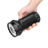 Hand holding an Olight Marauder 3 high-powered tactical LED flashlight isolated on white background