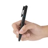 Hand holding a black tactical pen with blue accents, a glass breaker, and penlight