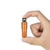 Hand holding small orange Olight flashlight, compact size, bright LED, portable light, everyday carry tool.