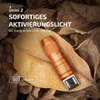 Orange Imini 2 flashlight, 50 lumens, integrated USB plug, on a bed of dry leaves.