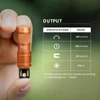 Hand holding orange Olight iMini 2, a 50 lumen keychain flashlight with 60 minute runtime and 21 meter throw.