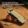Golden bead blasted TC4 titanium folding knife handle on brown canvas background