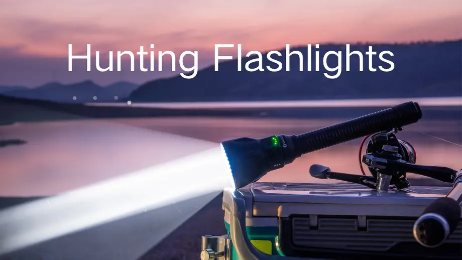 Bright hunting flashlight, fishing rod on cooler, lake at sunset.