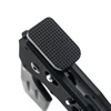 Black textured steel thumb rest pedal for competition pistol grip frame isolated on white background