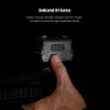 Hand pressing the dedicated NV button on a red dot sight to switch between daylight and night vision modes