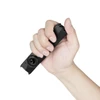 Hand holding a compact black EDC flashlight showing its portable size and rotary switch dial