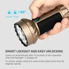 Hand operating a gold Marauder Mini flashlight with smart lockout and easy unlocking feature.